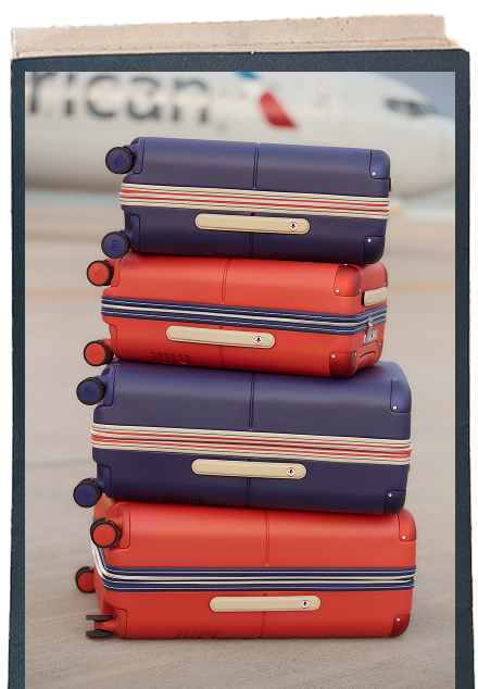 Stack of navy and red July suitcases